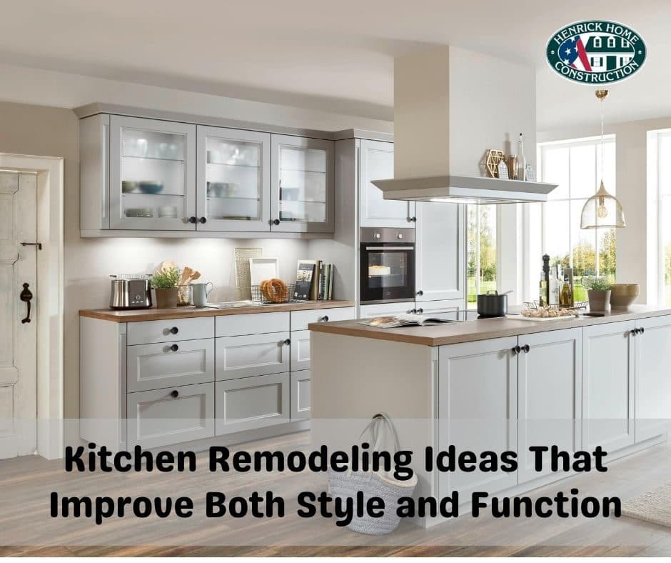 Remodeled kitchen with white cabinetry and pendant lighting over a center island